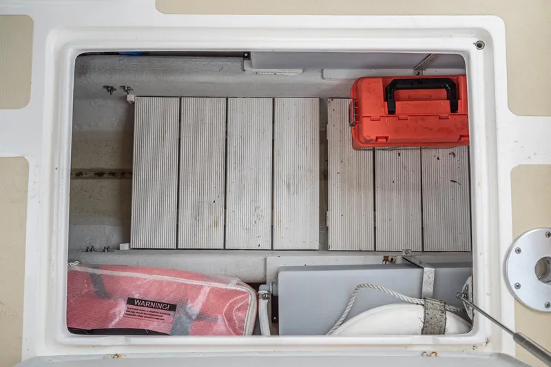 Slide: The Image of Storage compartment of a 2006 Hunt Yachts Harrier 25 with tools and equipment. - 36