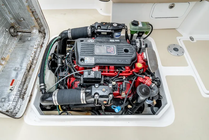 Slide: The Image of Engine compartment of a 2006 Hunt Yachts Harrier 25, showcasing a Volvo Penta engine. - 38