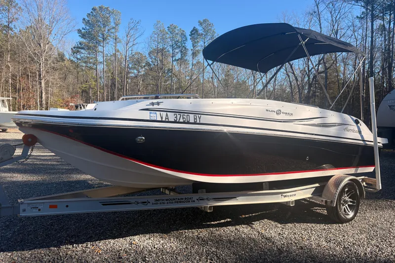 The Image of 2015 Hurricane SunDeck Sport 188 IO boat on trailer, parked outdoors. - 0