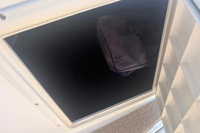 Slide: The Image of Storage compartment on 2015 Hurricane SunDeck Sport 188 IO boat with a bag inside. - 10