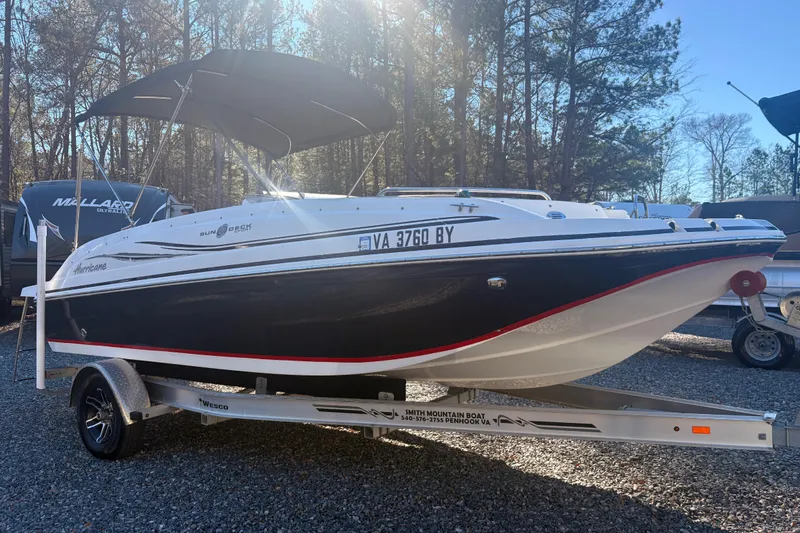 Slide: The Image of 2015 Hurricane SunDeck Sport 188 IO boat on trailer, parked outdoors. - 3