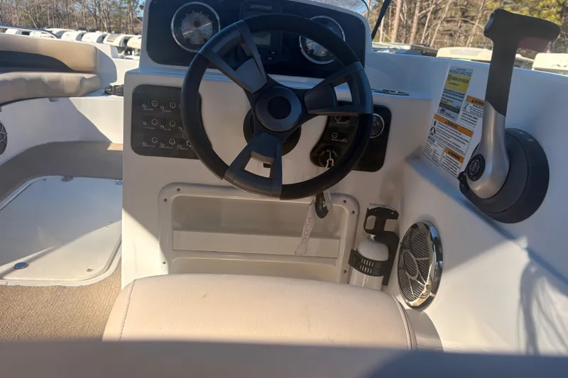 Slide: The Image of 2015 Hurricane SunDeck Sport 188 IO boat interior with steering wheel and controls. - 4