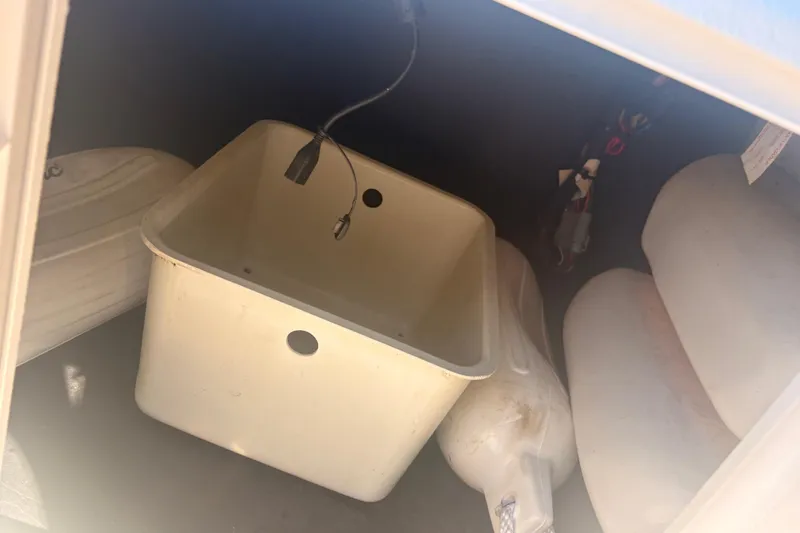 Slide: The Image of Storage compartment of 2015 Hurricane SunDeck Sport 188 IO boat with equipment. - 9