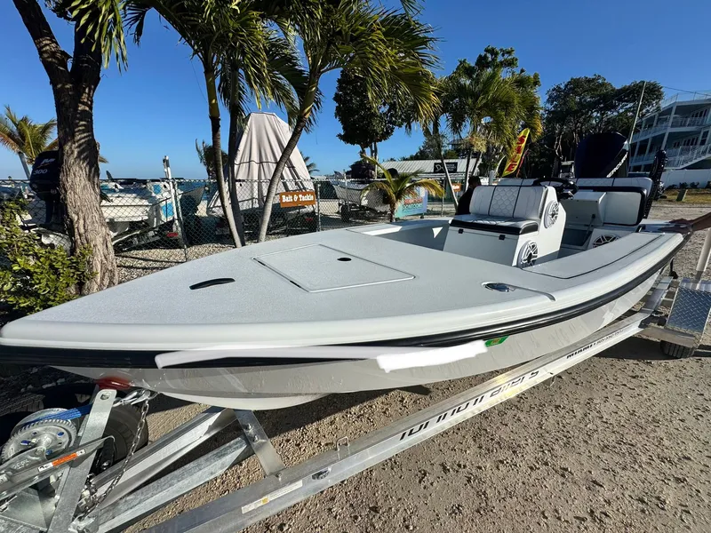 Slide: The Image of Vtech 18 FLATS boat 2026 on trailer, surrounded by palm trees. - 14