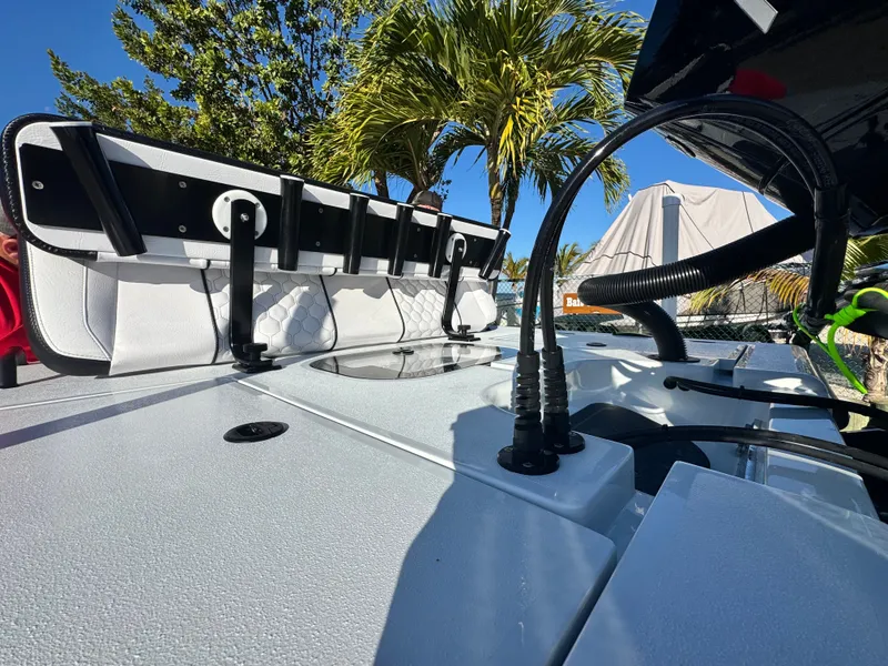 Slide: The Image of Vtech 18 FLATS 2026 boat with modern features and palm trees in background. - 17