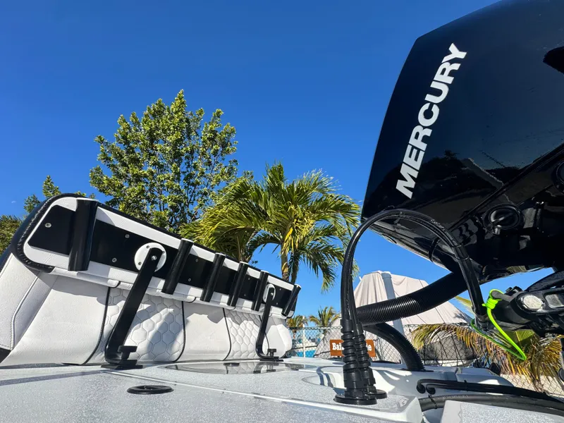 Slide: The Image of Vtech 18 FLATS boat with Mercury engine, palm trees in background. - 18