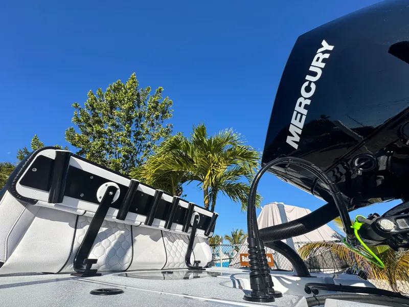 Slide: The Image of Vtech 18 FLATS boat with Mercury engine, palm trees in background. - 19