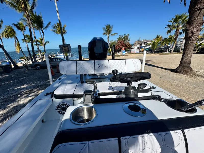 Slide: The Image of Vtech 18 FLATS boat, 2026 model, parked by the beach. - 38