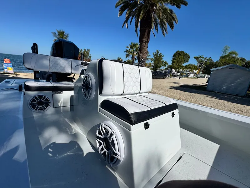 Slide: The Image of Vtech 18 FLATS boat, luxurious seating, speakers, palm trees in background. - 39