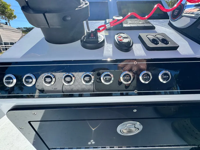 Slide: The Image of Vtech 18 FLATS 2026 boat console with switches and controls. - 41