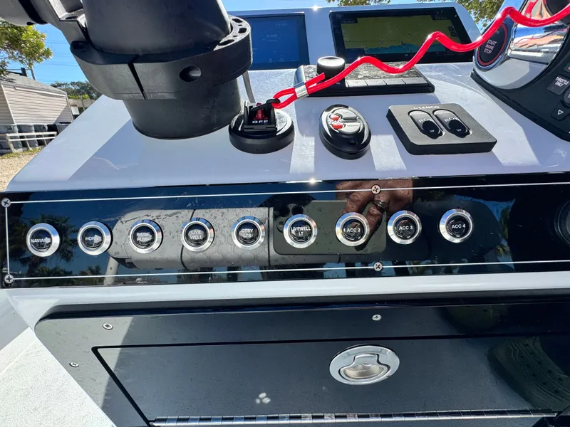 Slide: The Image of Vtech 18 FLATS 2026 boat console with switches and controls. - 42