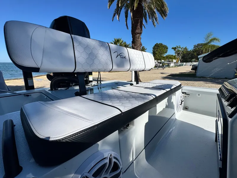 Slide: The Image of Vtech 18 FLATS boat 2026 with stylish white seats by the beach. - 43