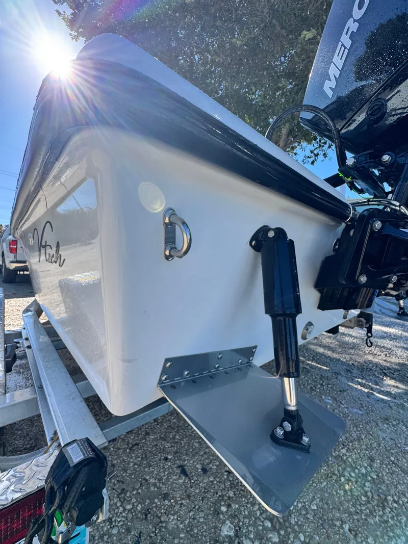 Slide: The Image of Vtech 18 FLATS boat 2026 with outboard motor, sunlight in background. - 46