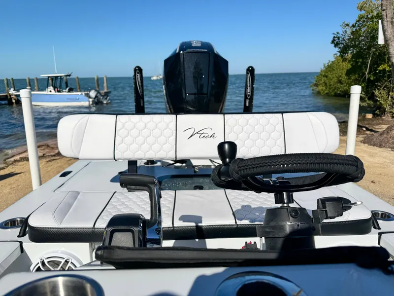 Slide: The Image of Vtech 18 FLATS boat, helm view, at beach, 2026 model. - 5