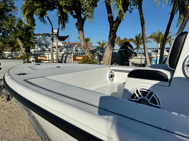 Slide: The Image of Vtech 18 FLATS boat 2026, white, parked under palm trees. - 9
