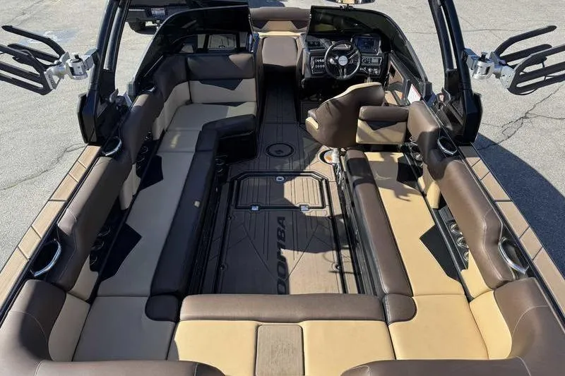 Slide: The Image of 2021 Moomba Makai boat interior with spacious seating and modern dashboard. - 10