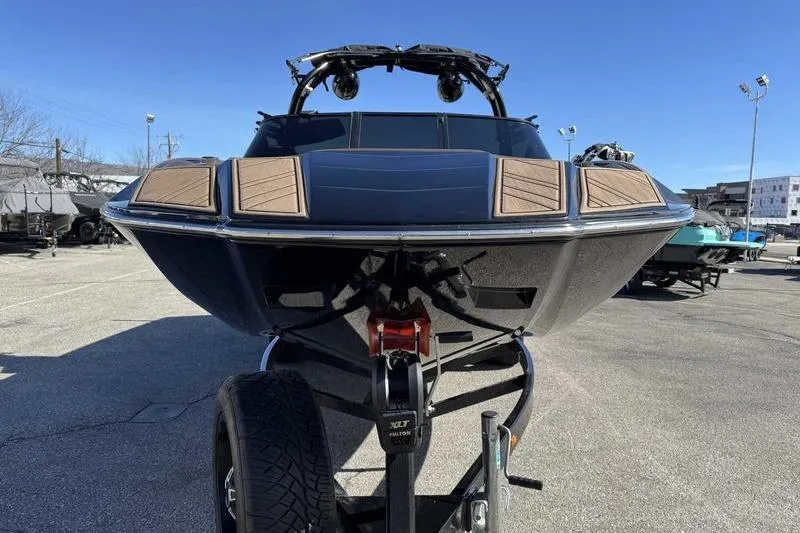 Slide: The Image of 2021 Moomba Makai boat on trailer, displayed outdoors under clear blue sky. - 3