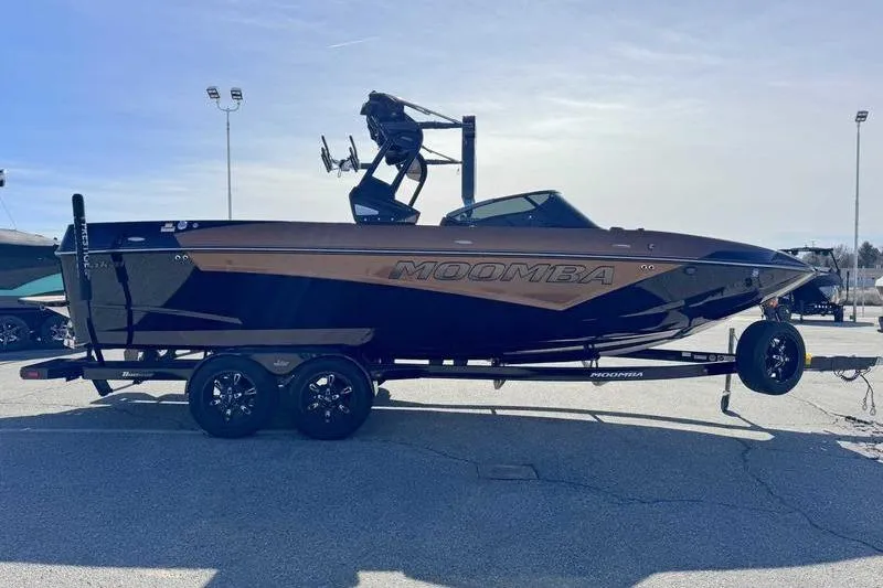 Slide: The Image of 2021 Moomba Makai boat on trailer, parked outdoors under clear sky. - 5
