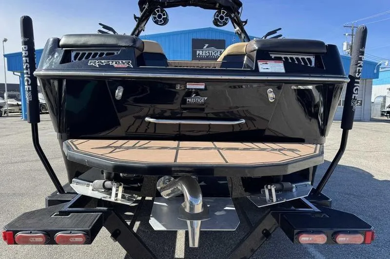 Slide: The Image of 2021 Moomba Makai boat rear view at Prestige dealership, showcasing Raptor engine. - 7