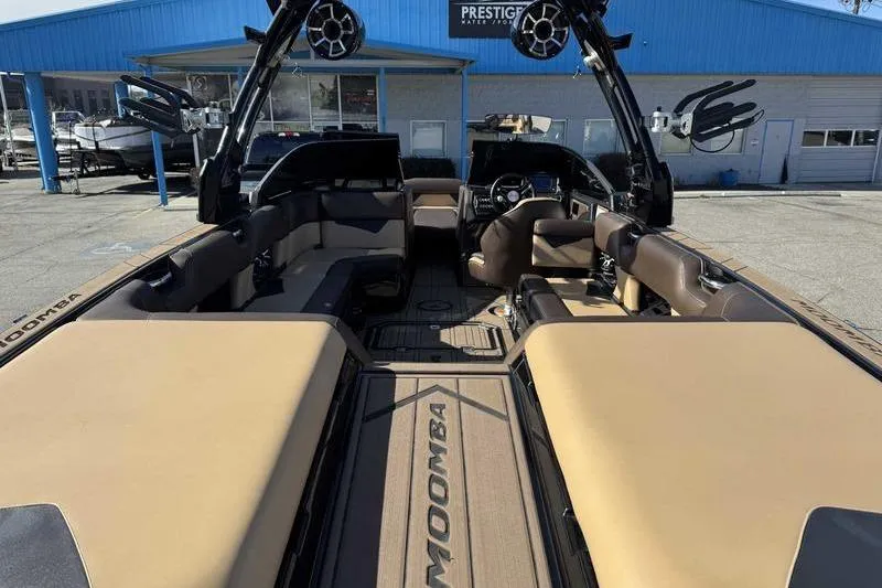 Slide: The Image of 2021 Moomba Makai boat interior with tan seating and modern design at Prestige Water Sports. - 9