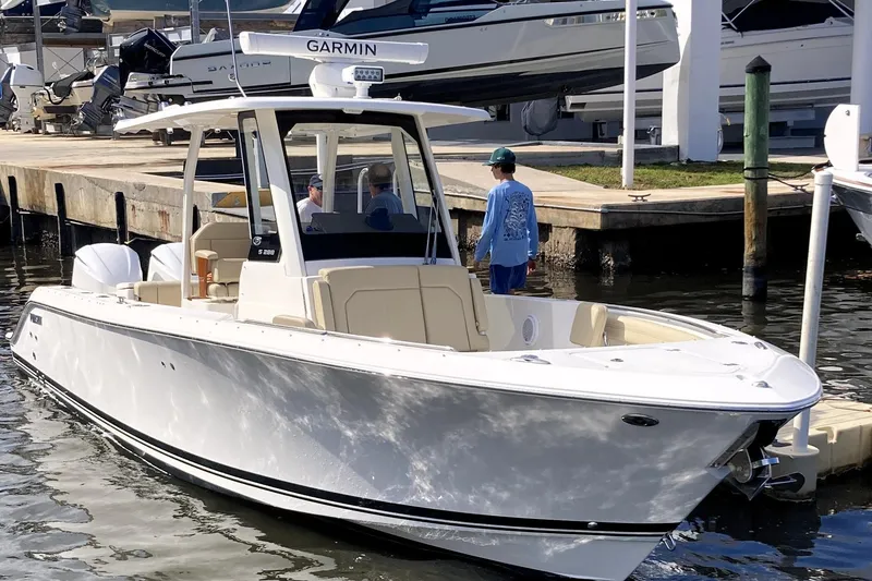 Slide: The Image of 2019 Pursuit S 288 Sport boat docked at marina with people onboard. - 13