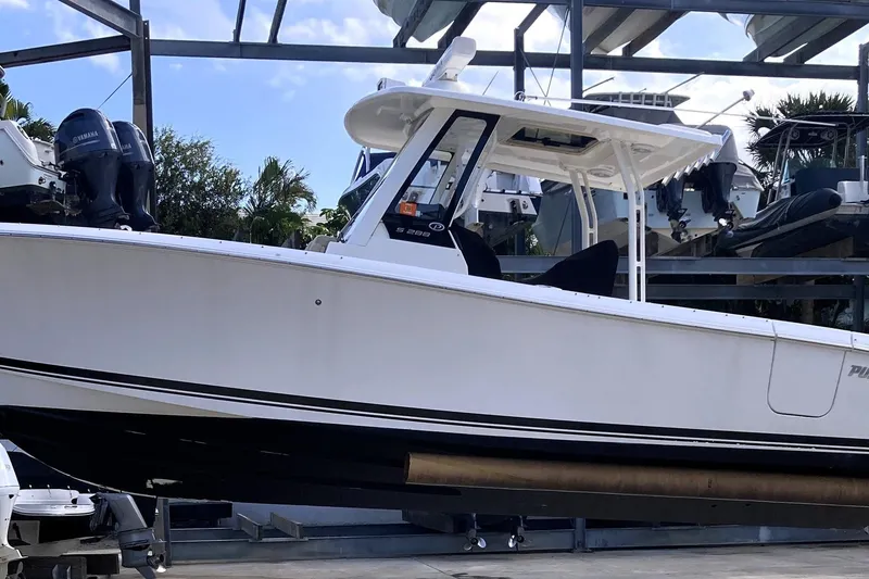 Slide: The Image of 2019 Pursuit S 288 Sport boat on display in a marina setting. - 14