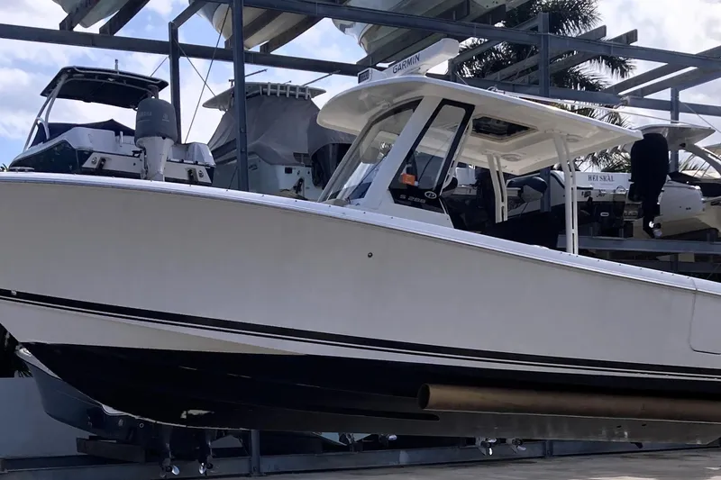 Slide: The Image of 2019 Pursuit S 288 Sport boat on display in a marina setting. - 15