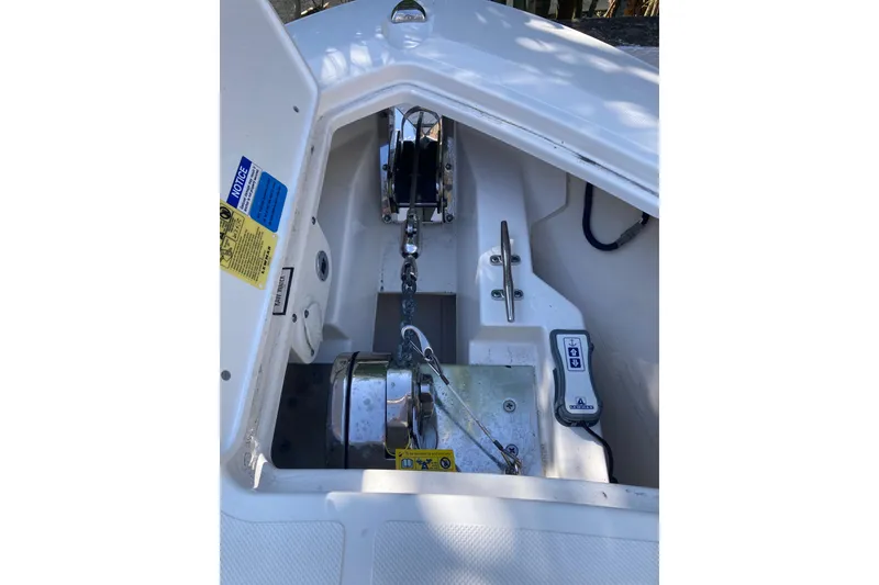 Slide: The Image of 2019 Pursuit S 288 Sport anchor compartment with chain and winch system. - 19