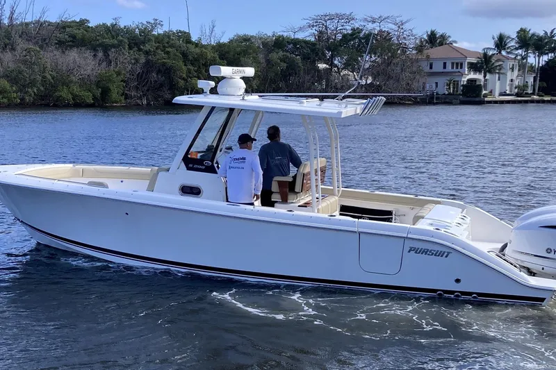 Slide: The Image of 2019 Pursuit S 288 Sport boat cruising on a calm waterway. - 2
