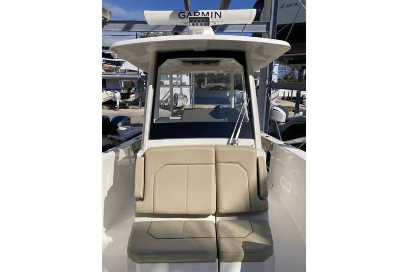 Slide: The Image of 2019 Pursuit S 288 Sport boat with beige seating and Garmin equipment. - 22