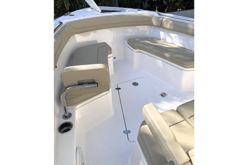 Slide: The Image of 2019 Pursuit S 288 Sport boat interior with beige seating and stainless steel accents. - 23