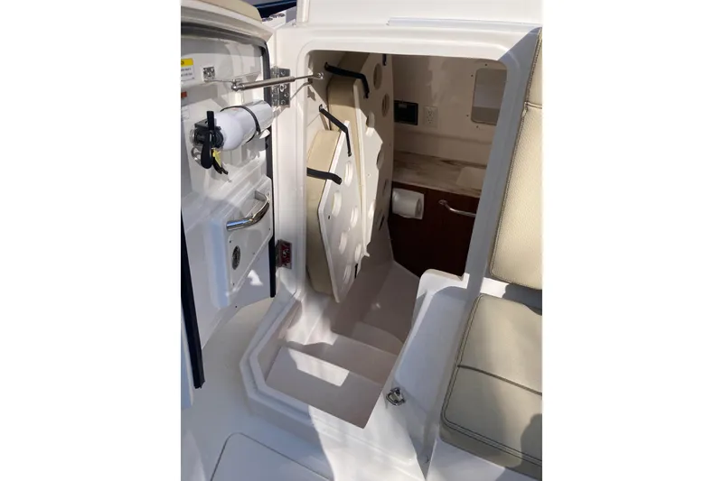 Slide: The Image of 2019 Pursuit S 288 Sport boat interior cabin with seating and storage. - 25