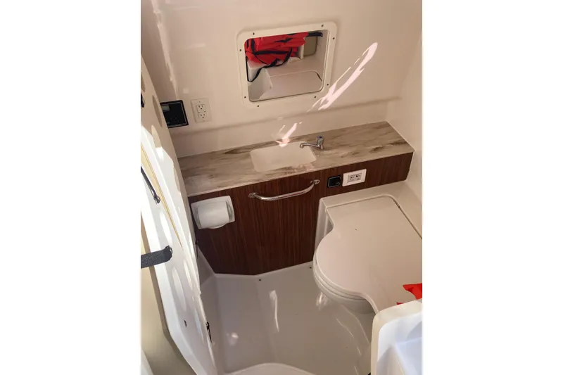 Slide: The Image of 2019 Pursuit S 288 Sport boat interior with sink and storage. - 27