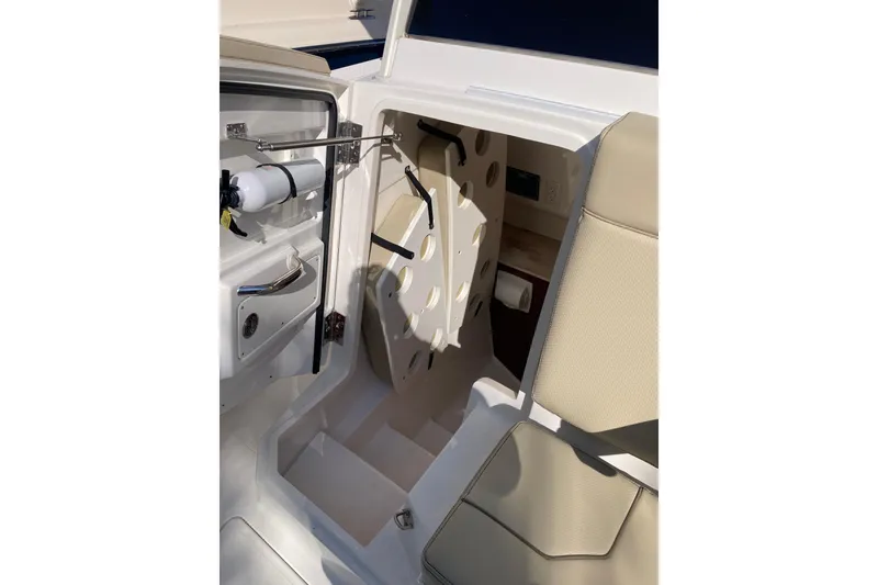 Slide: The Image of 2019 Pursuit S 288 Sport boat interior with seating and storage compartment. - 28