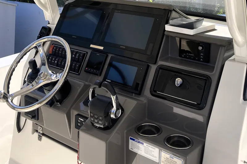 Slide: The Image of 2019 Pursuit S 288 Sport boat dashboard with steering wheel and electronic controls. - 31
