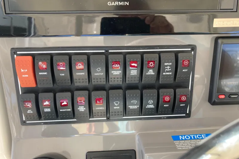 Slide: The Image of Control panel of a 2019 Pursuit S 288 Sport boat with labeled switches. - 37