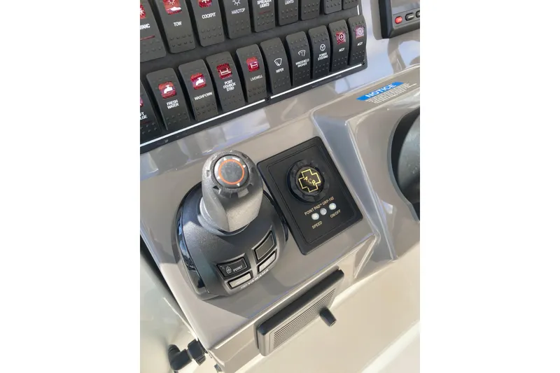 Slide: The Image of 2019 Pursuit S 288 Sport boat control panel with joystick and switches. - 38