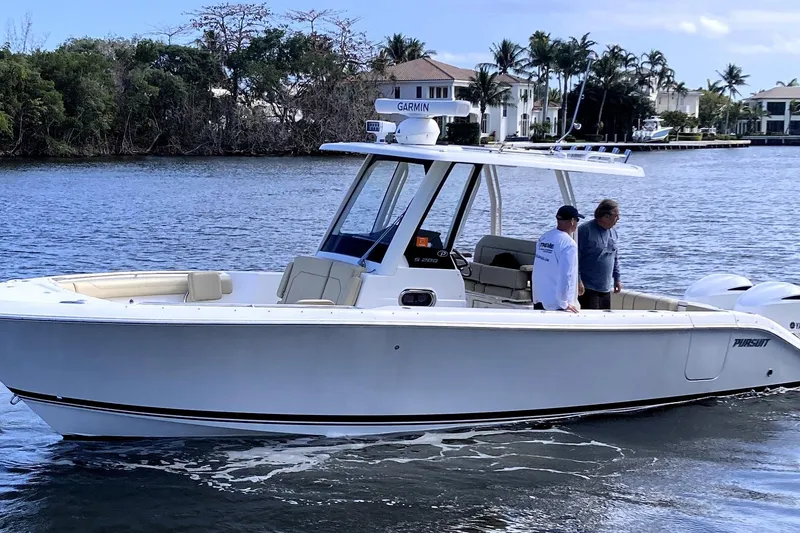 Slide: The Image of 2019 Pursuit S 288 Sport boat cruising on a scenic waterway with two people onboard. - 4