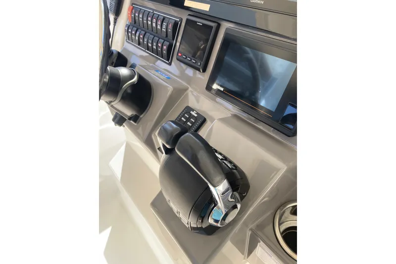 Slide: The Image of 2019 Pursuit S 288 Sport boat dashboard with controls and display screens. - 40