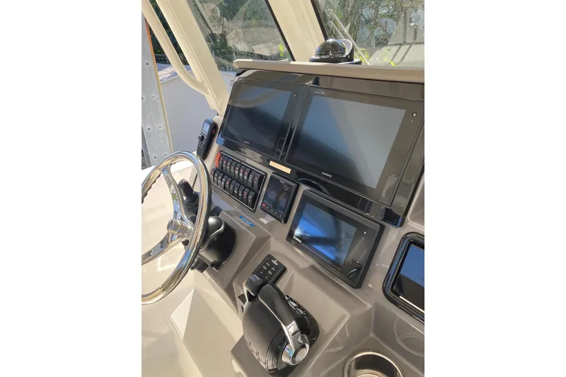 Slide: The Image of 2019 Pursuit S 288 Sport boat dashboard with modern navigation screens and controls. - 41