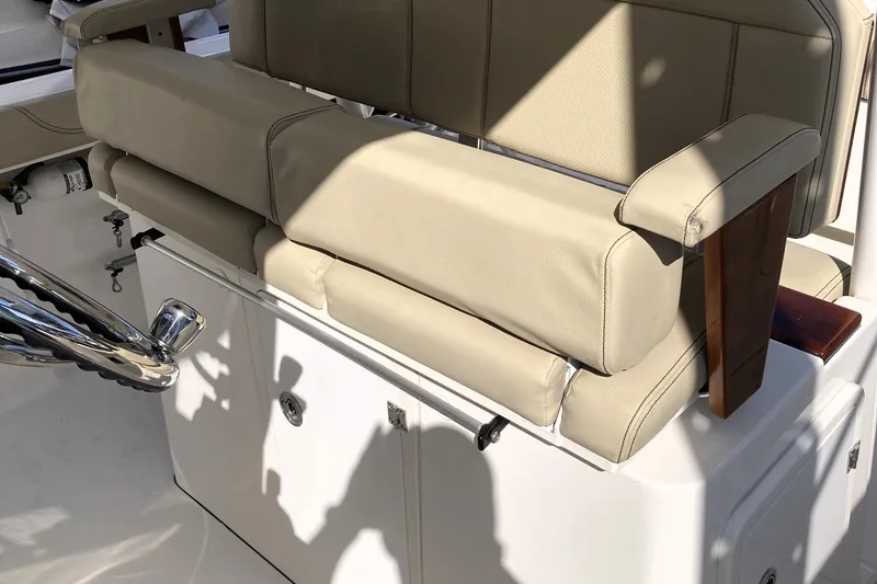 Slide: The Image of 2019 Pursuit S 288 Sport boat interior with beige seating and chrome details. - 43