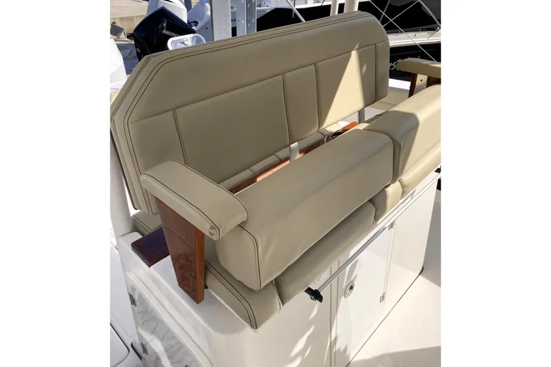 Slide: The Image of 2019 Pursuit S 288 Sport boat seat with beige upholstery and wooden accents. - 46