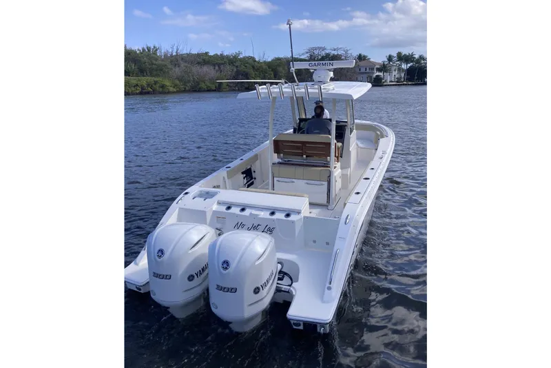 Slide: The Image of 2019 Pursuit S 288 Sport boat with twin Yamaha engines on a calm waterway. - 5