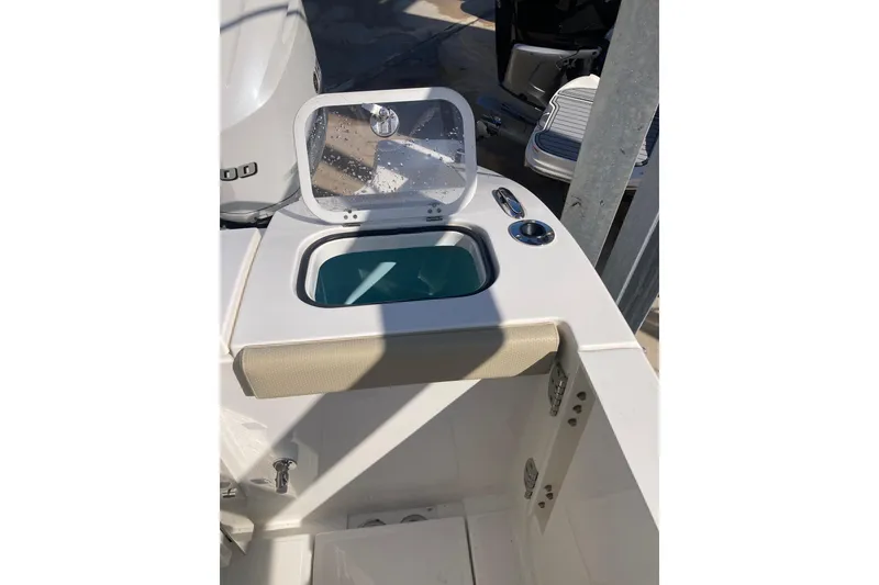 Slide: The Image of 2019 Pursuit S 288 Sport boat with open storage compartment and cup holder. - 56