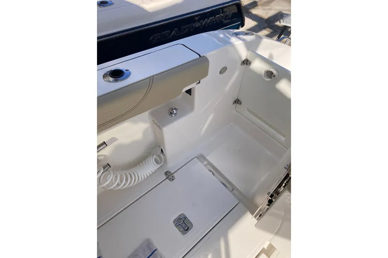 Slide: The Image of 2019 Pursuit S 288 Sport boat interior with storage compartment and coiled hose. - 59