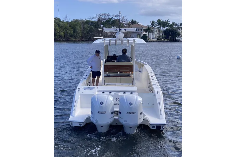Slide: The Image of 2019 Pursuit S 288 Sport boat on water with two people onboard. - 6