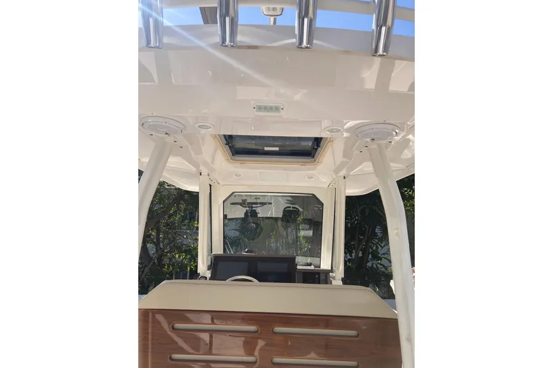 Slide: The Image of 2019 Pursuit S 288 Sport boat interior with helm and overhead rod holders. - 61
