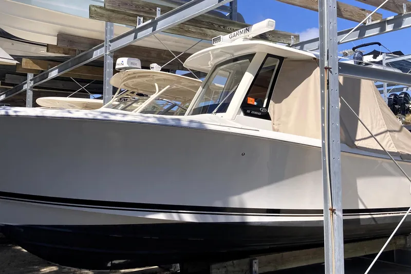 Slide: The Image of 2019 Pursuit S 288 Sport boat in storage, featuring Garmin equipment. - 63