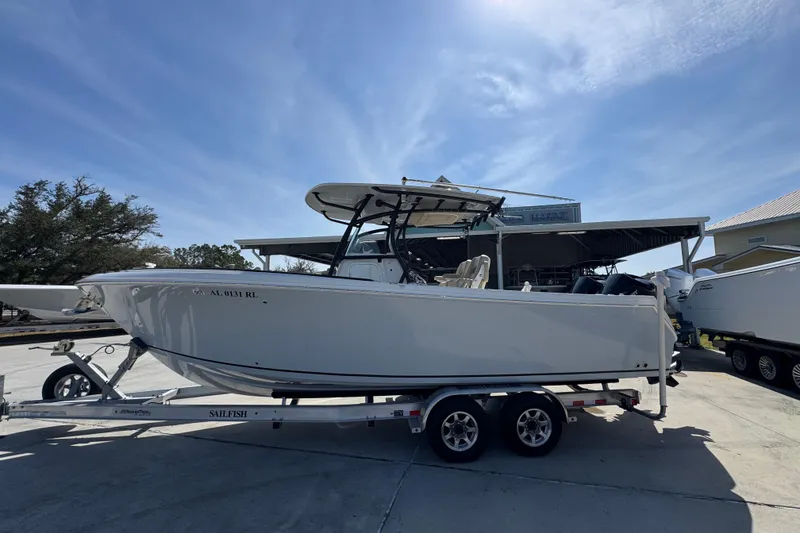 The Image of 2019 Sailfish 270 CC boat on trailer under clear sky. - 1