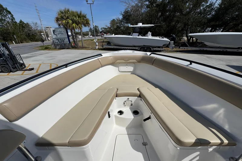 Slide: The Image of 2019 Sailfish 270 CC boat interior with beige seating and spacious deck. - 16
